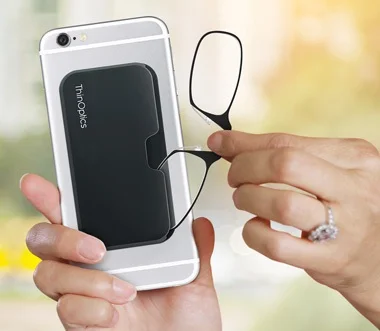 ThinOptics reading glasses attached to the back of a phone